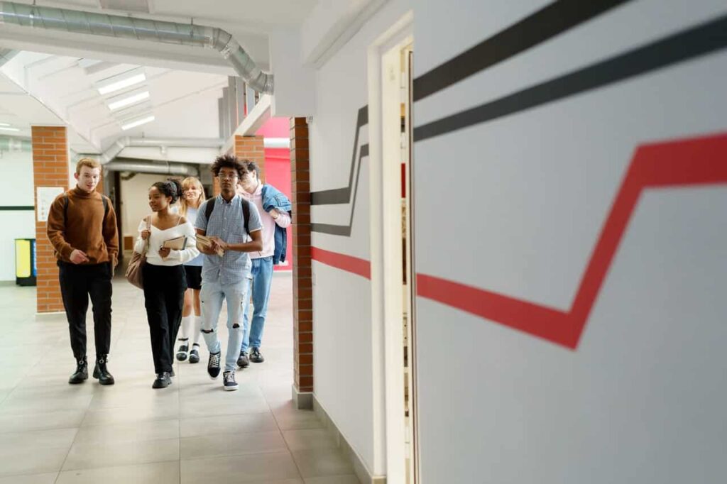 group of students walking in a high school hallway