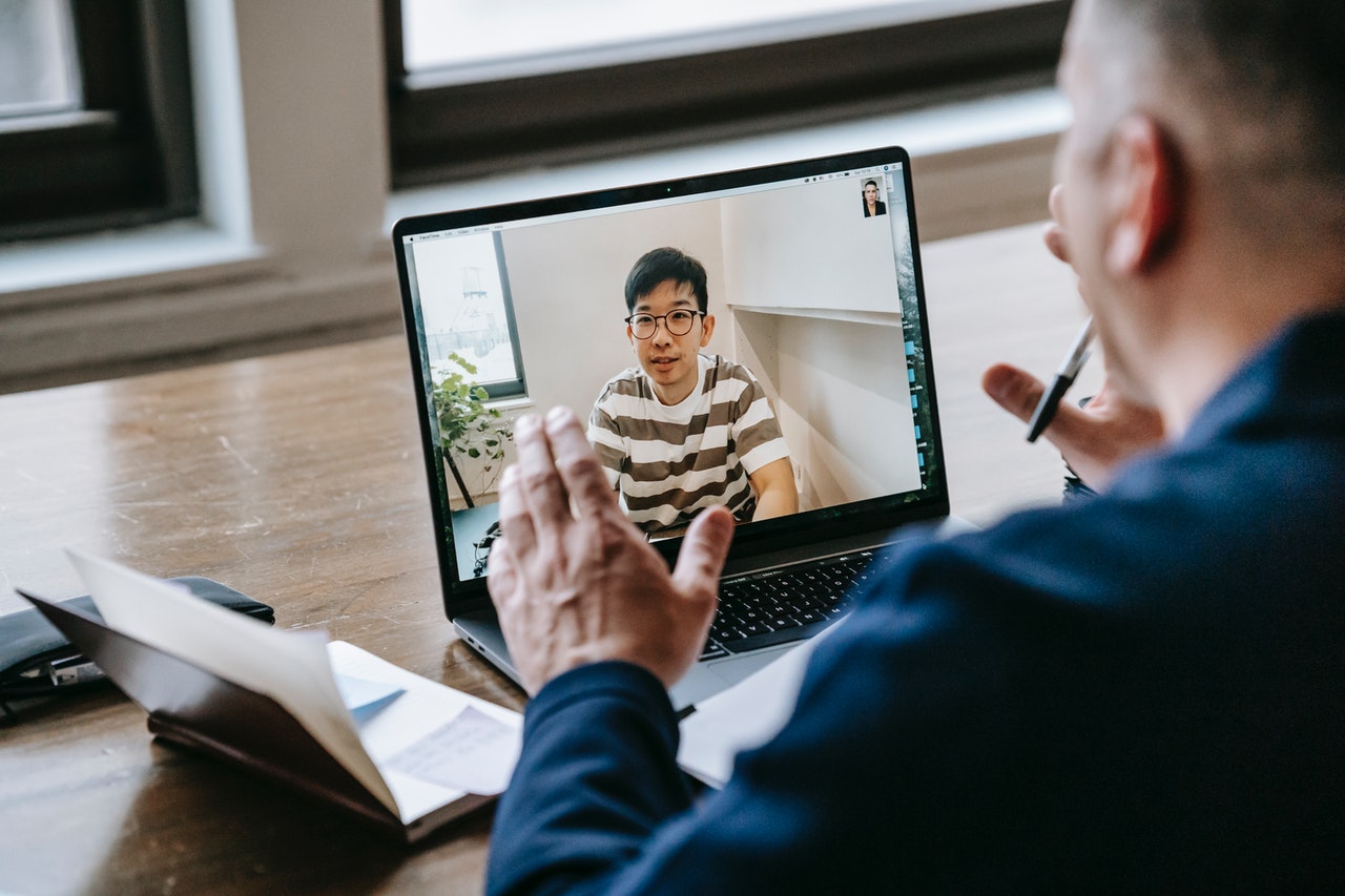 A young student talking to his mentor via Zoom 