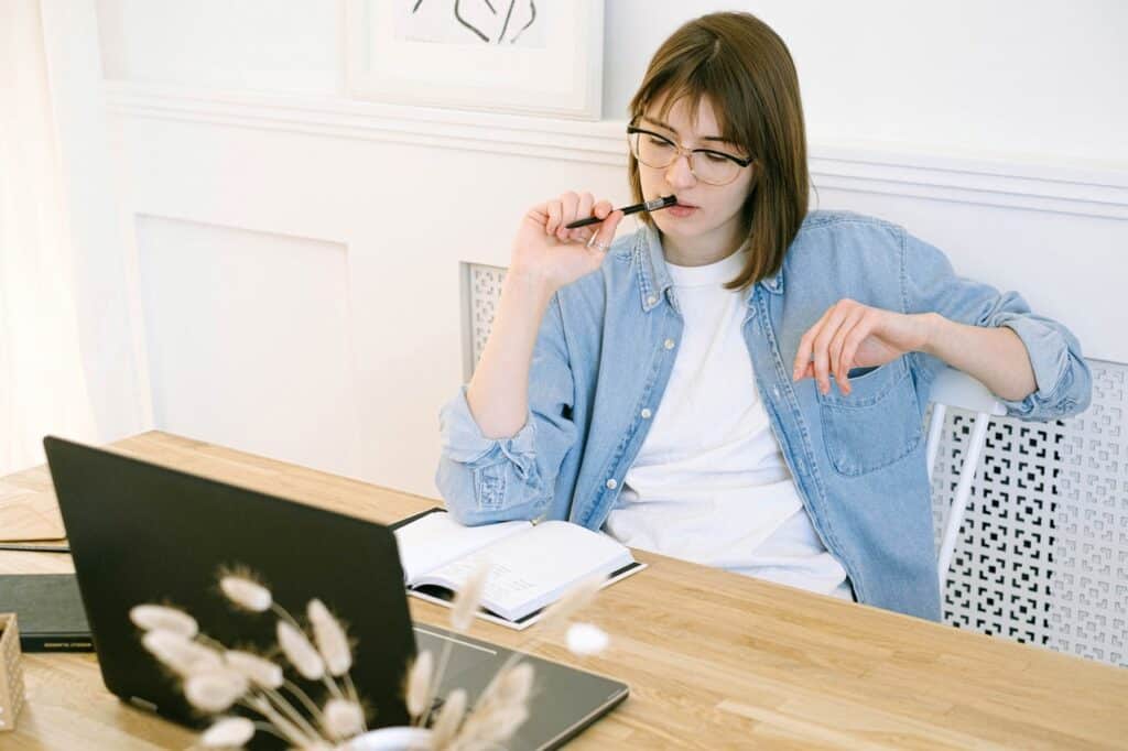 young woman sitting down in a pensive state