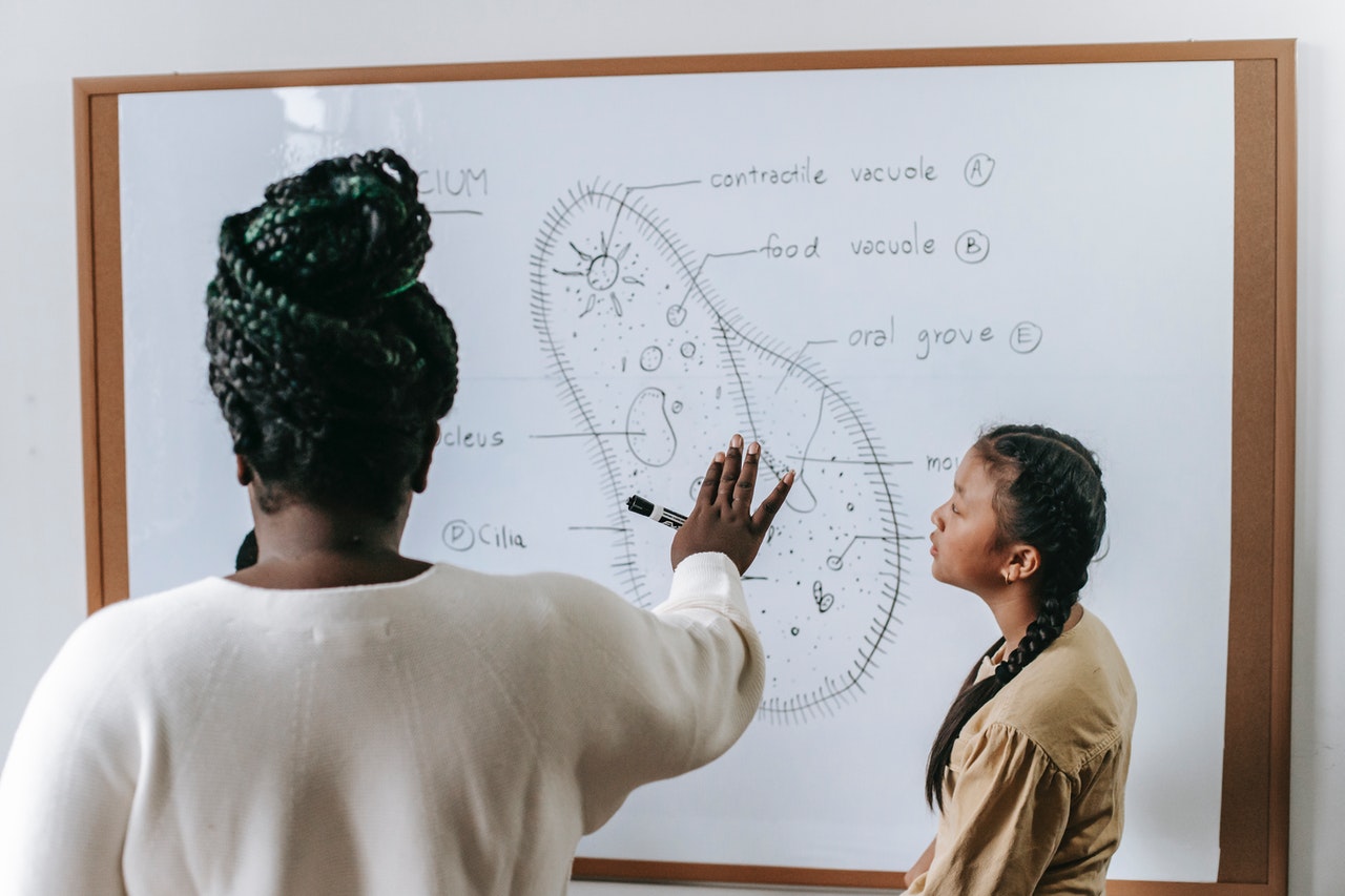 teacher showing student problem solving skills in the classroom 