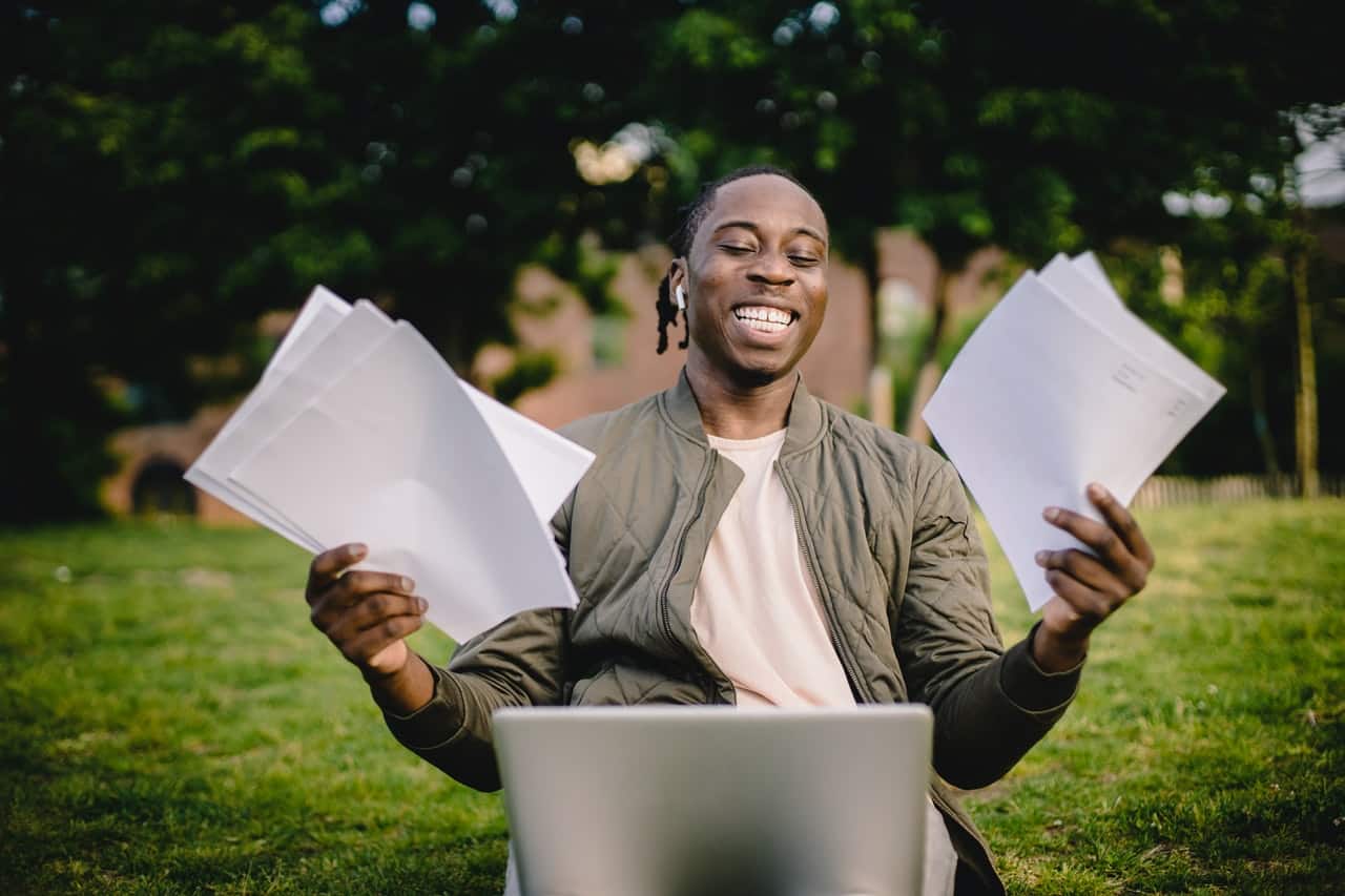 student with documents in his hand