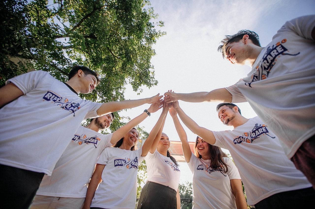 a group of friends holding hands 