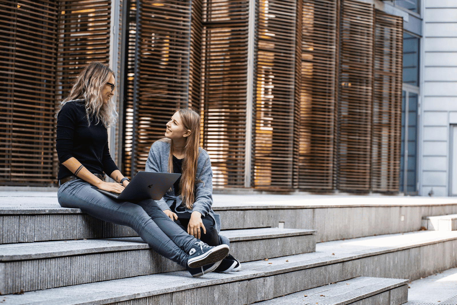 two woman smiling at each other