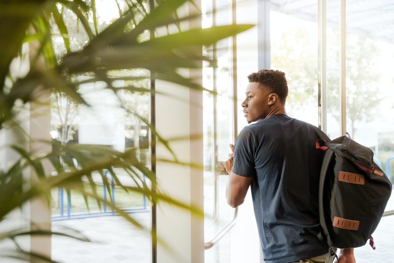 a student walking out of a classroom 