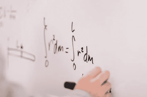 Math equation written on a whiteboard