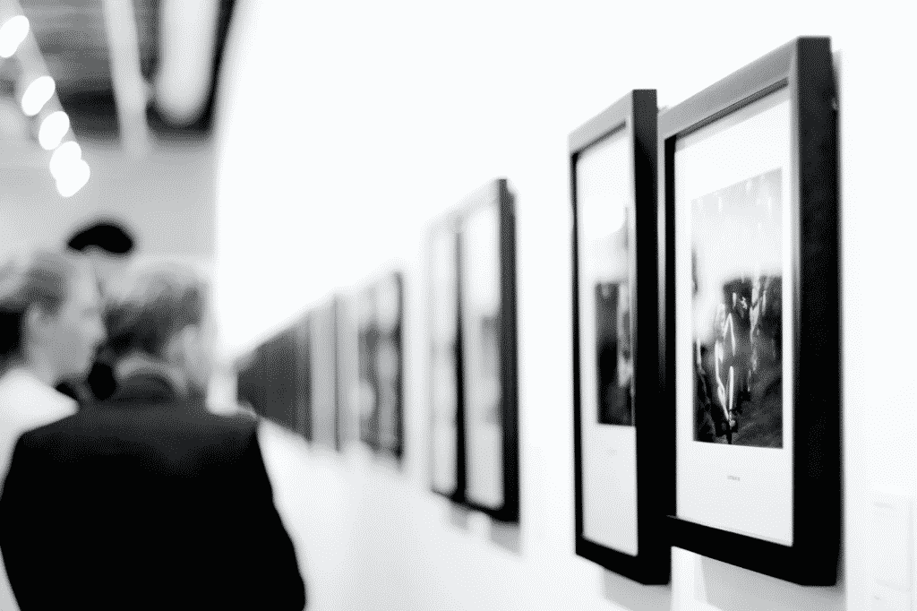 people looking at photographs at a photography exhibition