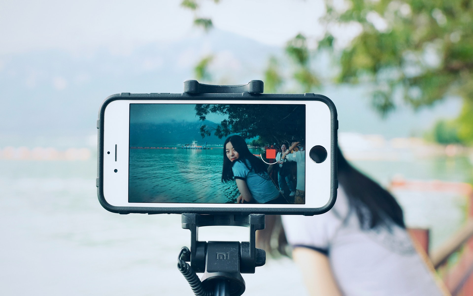 woman live streaming at the park 