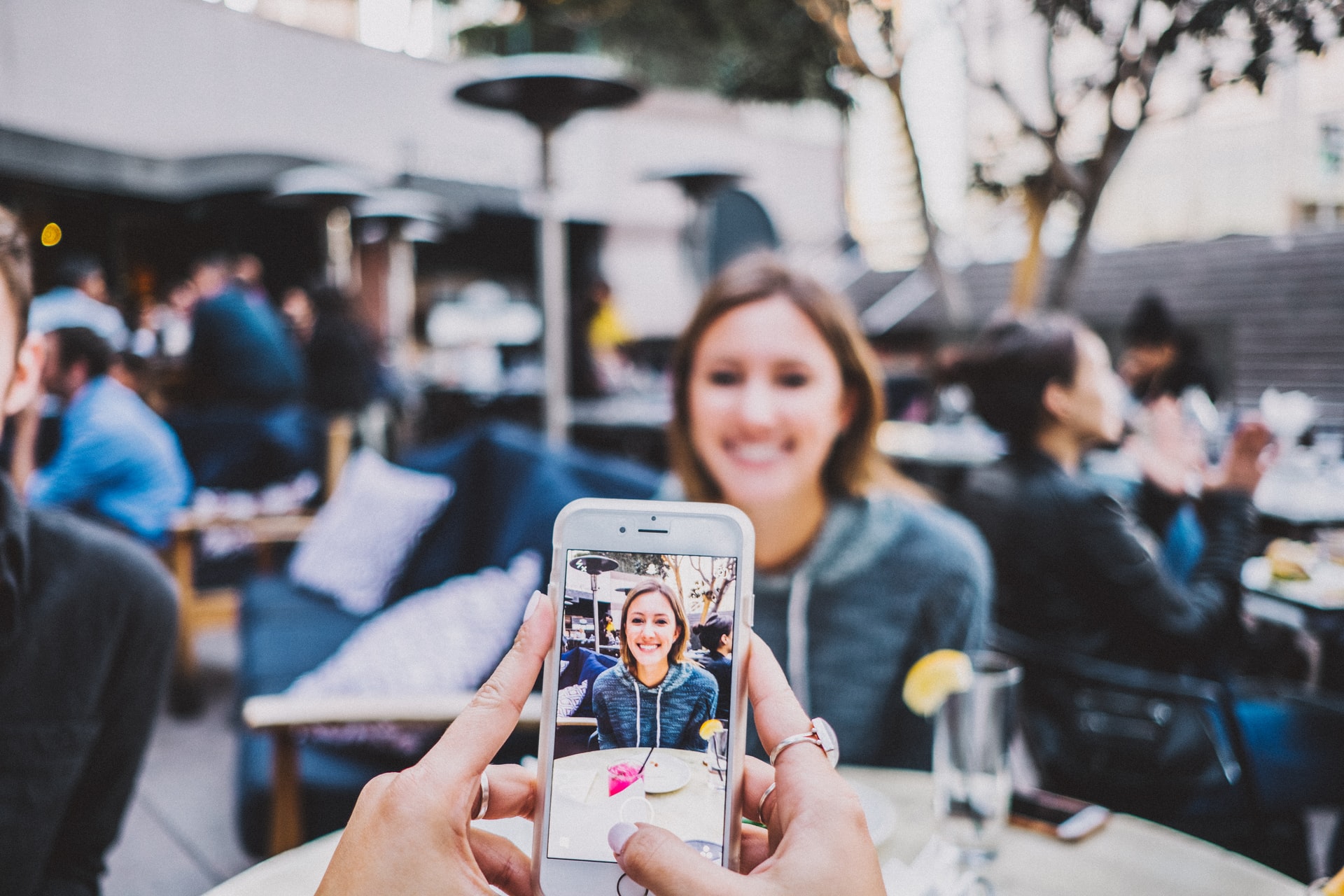 person taking a picture of a friend for Instagram