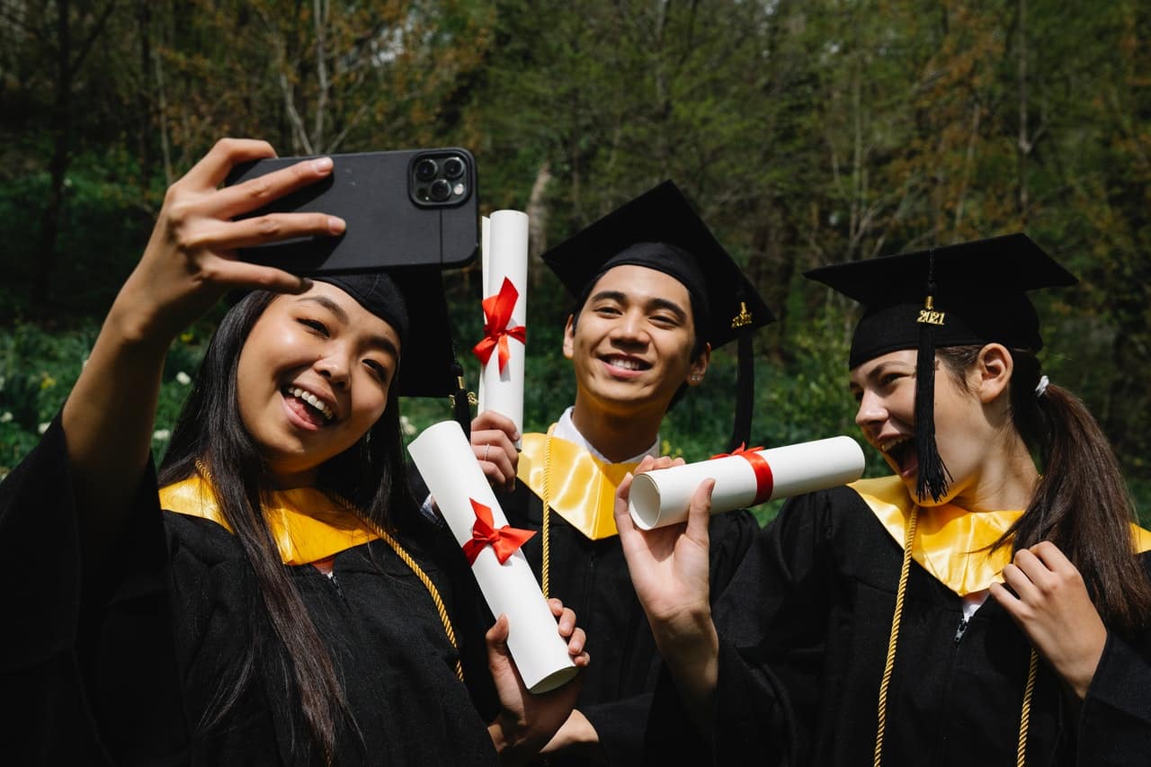 group of kids taking a selfie on graduation day