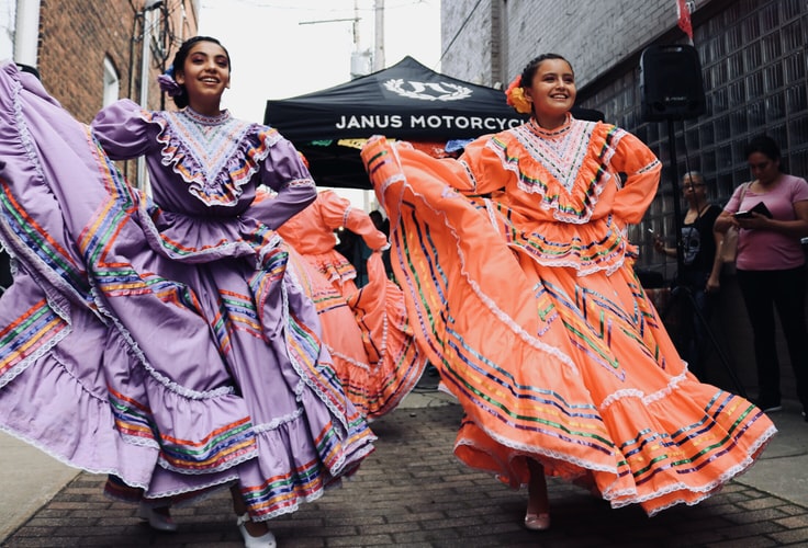 two women performing a cultural dance