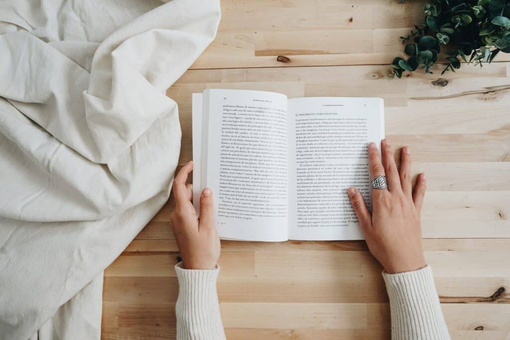 teen reading a book at home